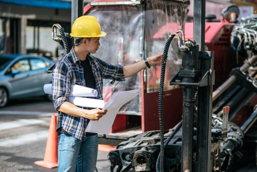 Civil engineers work on large road and machinery conditions.