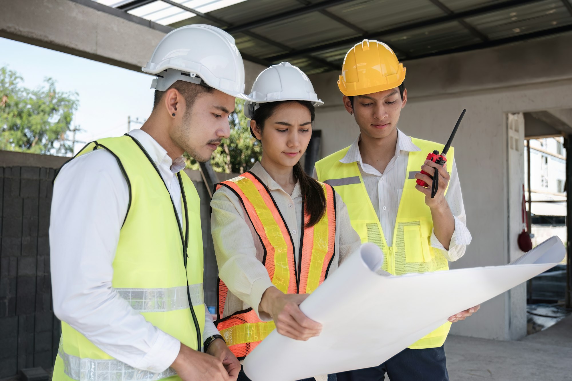 team of civil engineers and architects wearing hard hats Currently in a brainstorming meeting